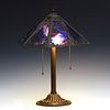 A BRADLEY AND HUBBARD LAMP WITH PURPLE AND BLUE GLASS