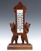 BLACK FOREST CARVING OF BEARS PRESENTING A THERMOMETER
