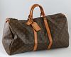 Louis Vuitton Brown Monogram Coated Canvas 55 Keepall Travel Bag, the vachetta leather handles with golden brass hardware and lock a...
