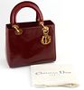 Christian Dior Burgundy Micro Diorissimo Patent Leather MM Lady Handbag, with golden brass accents and hanging "D-i-o-r" keychain, o...