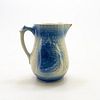 Blue salt glaze pitcher with village scene