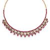 A silver, 18K yellow gold, ruby and diamond necklace
