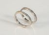 Two Hidalgo 18 Karat White Gold Bands
each with small channel set diamonds
size 6 1/2
5.5 grams