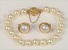Three Piece Pearl Suite 
to include 14 karat gold clasp, and pair pearl earrings, set in 14 karat gold 
length 7 inches
8.6 millimeters