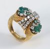 18 Karat Yellow Gold Ring
set with eight emeralds, and thirty-two diamonds
size 6 1/2
15.2 grams