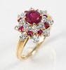 J. F. Caldwell 18 Karat Yellow Gold Ring
set with center ruby, encircled by eight diamonds, then by eight rubies, and ending in eight diamonds
size 5 