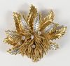 18 Karat Gold Leaf-Style Brooch
six fern leaves set with diamonds and gold tassels, approximately one hundred fourteen diamonds
width 2 1/2 inches
49.