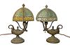 Pair of Diminutive Table Lamps
with six sided slag glass shades, on bases with fluid lamp design with face
height 12 inches, diameter 6 1/2 inches
Pro