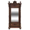 Armario. Francia. Siglo XX. Estilo Enrique II. En talla de madera de nogal. Con puerta abatible con espejo de luna rectangular.