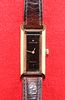 A LADYS GOLD-PLATED HAMILTON STRAP WATCH. Rectangular brown