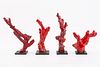 FOUR RED CORAL NATURALISTIC TREE FORM SCULPTURES