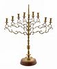 E. 20TH C. CONTINENTAL BRASS MENORAH ON STAND