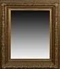 American Aesthetic Style Gilt and Gesso Mirror, 19th c., with an ornate stepped relief leaf frame around a wide beveled plate, H.- 44 in., W.- 35 in.,