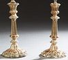 Pair of Silverplated Copper Candlesticks, early 20th c., with knopped and reeded supports, to a weighted scalloped sloping relief decorated base, now 