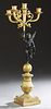 French Gilt and Patinated Bronze Figural Five Light Candelabra, 19th c., with four cornucopia arms around a central torch form candleholder, upheld by
