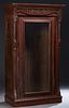 American Carved Walnut Armoire, c. 1880, the stepped crown over a leaf carved frieze above a glazed door, flanked by turned and reeded pilasters, on a