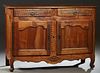 French Provincial Louis XV Style Carved Cherry Sideboard, 19th c., the stepped canted corner top over two frieze drawers above double cupboard doors w