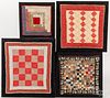 Four framed doll quilts