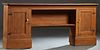 Louisiana Carved Pine Back Bar, 20th c., the canted corner top over a center shelf flanked by two beeded board cupboard doors, on a stepped plinth bas