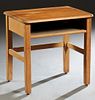 Louisiana Child's Carved Pine School Desk, early 20th c., the rounded edge and corner top with an indented pen groove, over open storage, on tapered s