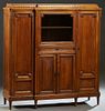 French Carved Oak Louis XVI Style Sideboard, early 20th c., the stepped sloping reeded breakfront top over a center glazed door above a frieze drawer 