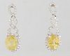 Pair of Platinum Pendant Earrings, with pierced oval diamond mounted studs, to an infinity bail and a pendant with a 2.14 carat oval yellow sapphire a