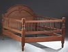 American Carved Walnut Youth Bed, late 19th c., the arched headboard with an applied roundel, to spindled rails and a spindled footboard, H.- 50 3/4 i