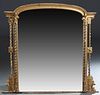 American Gilt and Gesso Overmantle Mirror, late 19th c., the arched top over an arched beveled plate flanking on each side by two rows of rope twist c