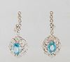 Pair of 14K White Gold Half Hoop Earrings, the diamond mounted floriform pendants with a 2.46 carat oval blue zircon, total zircon weight- 4.92 cts., 
