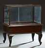 American Carved Oak Display Case, with a glass top front, sides and two rear sliding glass doors, on cabriole legs with toupie feet, H.- 40 1/2 in., W