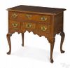 Philadelphia Queen Anne walnut dressing table, ca. 1760, with four drawers, a scalloped skirt