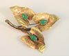 18 Karat Gold Triple Leaf Brooch
each set with green stones
marked Italy
8.5 grams total weight
Provenance: From the Lance & Irma Keller Collection, B