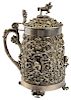 AN ORNATE PARCEL GILT SILVER TANKARD WITH CAST BUSTS AND APPLIED IVY, AUSTRIA, CIRCA 1861