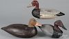 Three carved and painted duck decoys, one stamped Robert Elmore, 14 3/4'' l., a canvasback, 12'' l.
