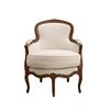 Sillón. Siglo XX. Estructura de madera, con tapicería textil color beige. Respaldo cerrado, asiento acojinado.