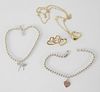 Tiffany & Company Four Piece Lot, to include two 14 karat gold hearts, 8.3 grams; one pin with triple heart; one heart on chain; along with two sterli