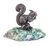 A Italian Silver Model of a Squirrel, 20th Century, depicted seated on a branch eating a nut, set on a quartz base.