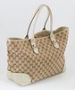Gucci Beige Monogrammed Canvas and Ivory Leather Heartbit Tote, the exterior with golden brass and bamboo heart charm, opening to a lined beige interi