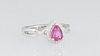 Lady's Platinum Dinner Ring, with a pear shaped untreated 1.02 ct. ruby, atop a border of tiny round diamonds, above pierced twisted shoulders of the 