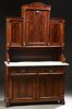 American Carved Walnut Marble Top Sideboard, 19th c., the arched crest over a large arched panel cupboard door, flanked by reeded pilasters and setbac