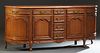 French Carved Cherry Louis XV Style Marble Top Sideboard, 20th c., the stepped rounded edge demilune pink marble over a central bank of four drawers, 