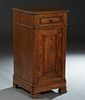 French Provincial Louis Philippe Carved Poplar Nightstand, 19th c., the stepped canted corner top over a frieze drawer and a long cupboard door, on a 
