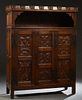 French Provincial Renaissance Style Carved Oak Sideboard, 19th c., the scrolled crown over open storage above three highly carved fielded panel doors 