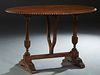 French Renaissance Style Carved Pine Oval Table, 19th c., the gadrooned edge oval top on a trestle form base joined by a rectangular stretcher, having