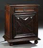 French Provincial Louis XIII Style Carved Oak Confiturier, 19th c., the stepped rounded edge top over a frieze drawer and a lower cupboard door with i
