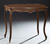 Louis XV Style Crotched Mahogany Center Table, early 20th c., the stepped ogee edge tortoise top over a shell carved skirt on both long sides, on reed