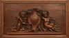 French Carved Oak Figural Panel, late 19th c., with high relief figures of putti flanking a central shield, presented in an oak frame, Carving- H- 11 