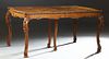 American English Syle Carved Burled Walnut Dining Table, 20th c., the carved edge bowed end top over a serpentine carved skirt, on well carved cabriol