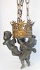 Bronze Putti Hanging Light, having three cherubs holding a crown form shade with one light, height of figure 16 inches.