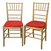 Set of Ten Faux Bamboo Chairs, gold with red slip seats, seat height 17 1/2 inches, total height 36 inches.